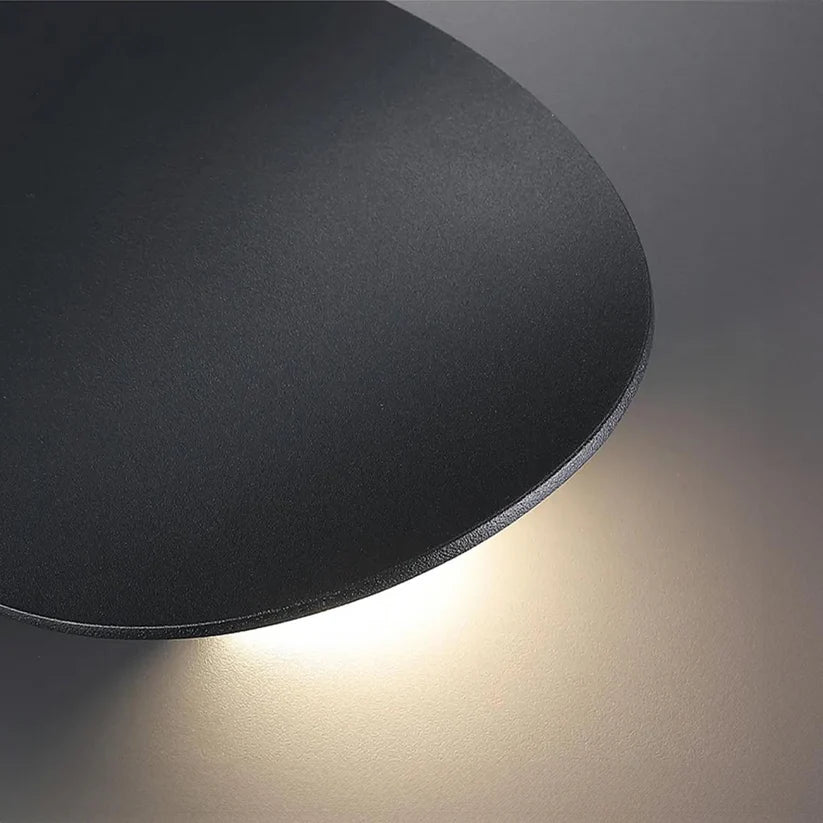 Modern Minimalist Wall Lamp with Organic Disc Shape and Warm LED Glow