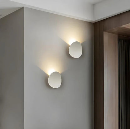 Modern Minimalist Wall Lamp with Organic Disc Shape and Warm LED Glow